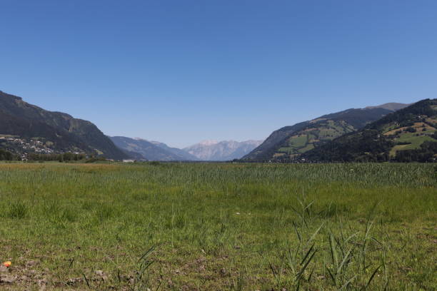 Empty field A large field with mountains in the back, zell am see nir stock pictures, royalty-free photos & images