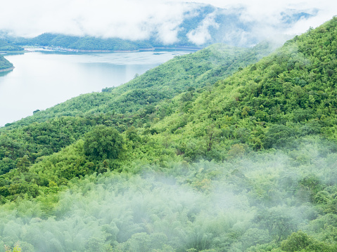 Srinakarin Dam (Khwae Yai River) with mist and cloud over lake water in the morning, Kanchanaburi Thailand