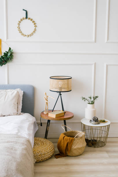 istock Cozy bedroom with a bed and a Christmas wreath, bedside table 1762848093