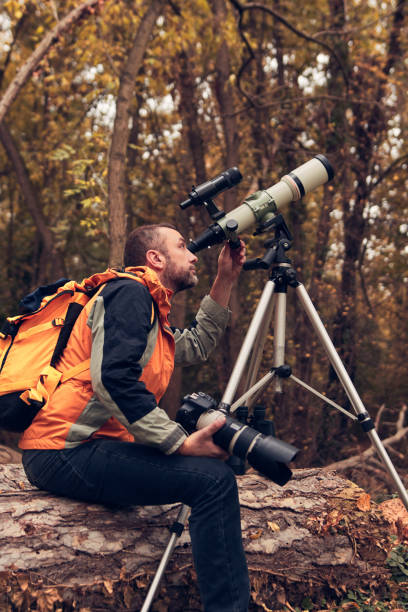 istock Man using telescope for bird and animal watching in nature. 1762850901