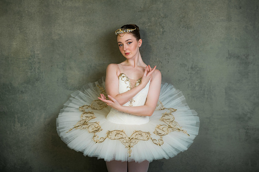 Young female ballerina standing on toes, low section