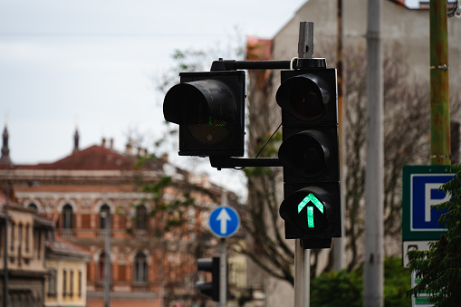 Traffic light with yellow light on, signal for proceed with caution.