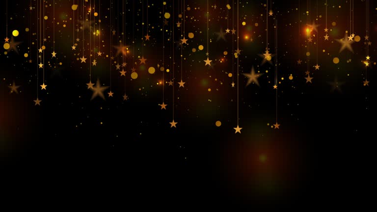 Glowing golden hanging stars and shiny particles abstract motion background