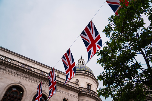 A flag featuring the St George's Cross, flying in the wind on a summer's day.