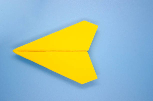 istock Top view of yellow airplane on light blue background with customizable space for text. Copy space and airplane concept. 1762913130