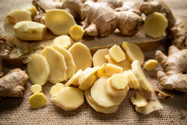 istock Ginger root and sliced ​​ginger fruit on a wooden table 1762934474