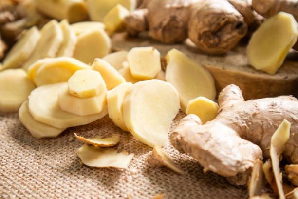 istock Ginger root and sliced ​​ginger fruit on a wooden table 1762934476