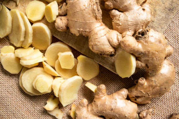 istock Ginger root and sliced ​​ginger fruit on a wooden table 1762934492