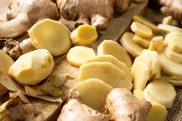 istock Ginger root and sliced ​​ginger fruit on a wooden table 1762934498