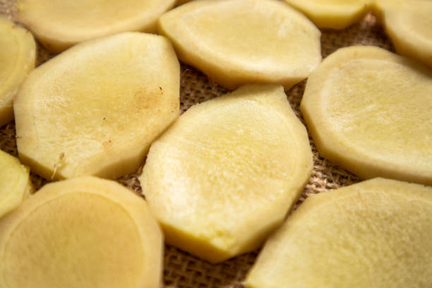 istock Close-up view of sliced ​​ginger fruit on wooden table 1762934504