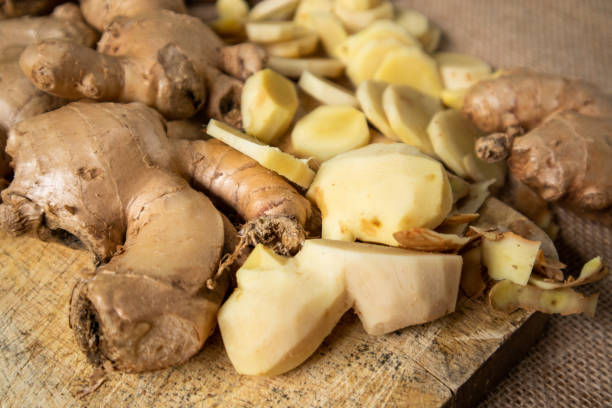 istock Ginger root and sliced ​​ginger fruit on a wooden table 1762934505