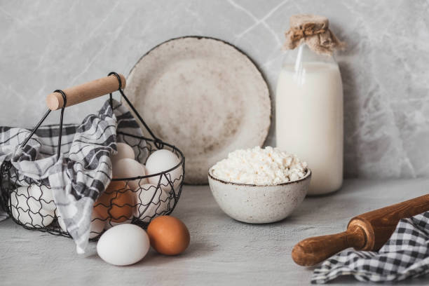 fresh dairy products, milk, cottage cheese, eggs in stylish ceramic dishes on a gray background. the concept of natural, dietary nutrition. useful products. - milk old fashioned retro revival still life imagens e fotografias de stock