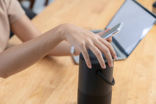 istock Modern Technology Concept. Young woman use portable speaker at home. 1762960480