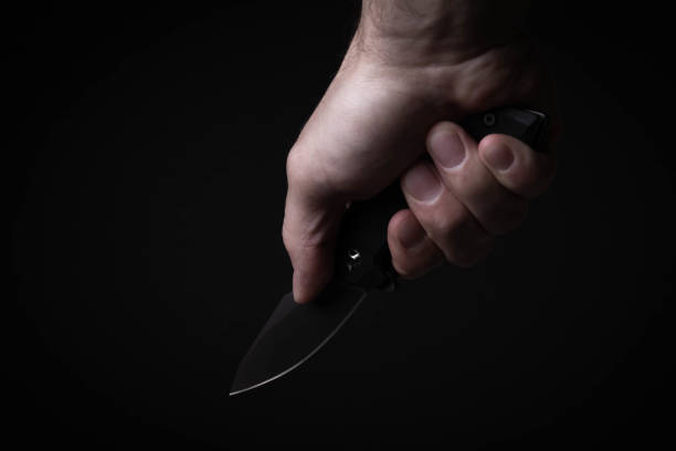 istock A sharp knife in the man's hand. The use of cold weapons. Knife attack . Armed raid. 1763011779