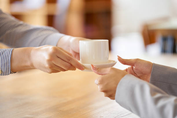 istock Cafe worker passing coffee over the counter 1763011796