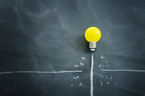 Education concept image. Creative idea and innovation. light bulb metaphor over blackboard background