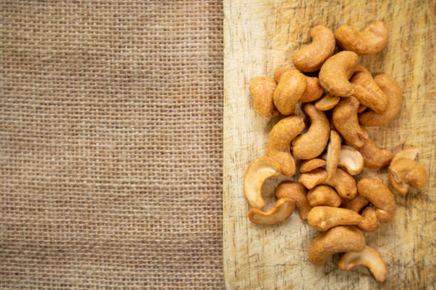 Cashew nuts on brown wooden background