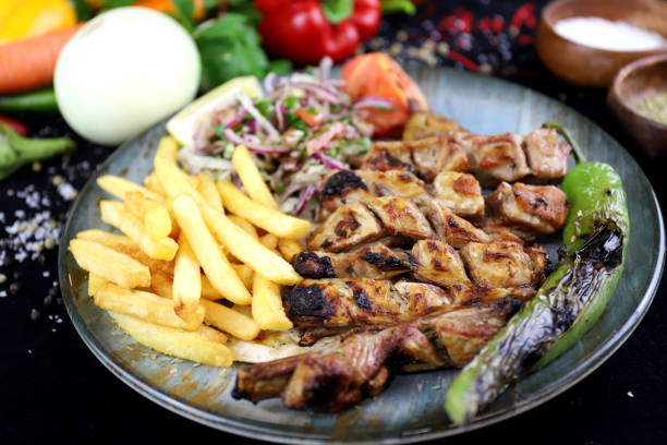Grilled ribs with fries and salad on a plate stock photo