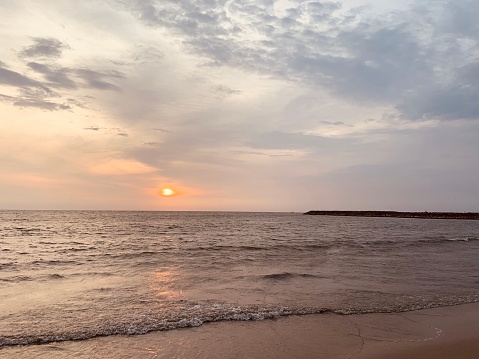 Beautiful view of Kozhikode beach with light water waves and sunset view with beautiful nature scenery of sky in background