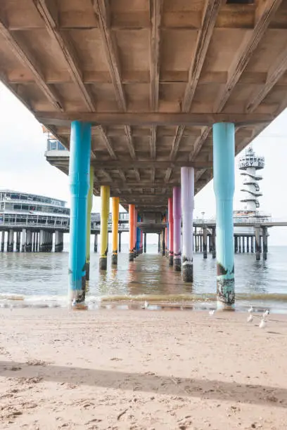 Photo of Colourful pedestals for a huge pier on the beach at Den Haag on the west coast of the Netherlands. American style beach