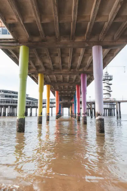 Photo of Colourful pedestals for a huge pier on the beach at Den Haag on the west coast of the Netherlands. American style beach