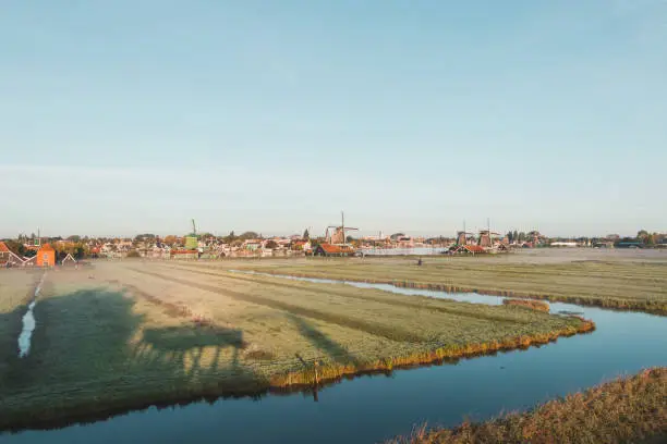 Photo of Popular tourist spot Zaanse Schans is near Amsterdam in the west of the Netherlands. Historical, realistic windmills during sunrise. Holland's landmark