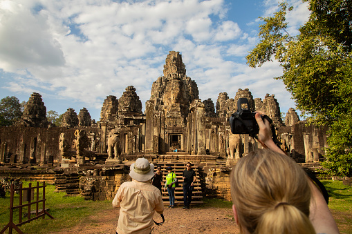 Scenic view of young Caucasian woman sitting in Borobudur temple at sunrise