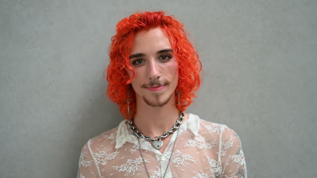 Young gay man with dyed red hair