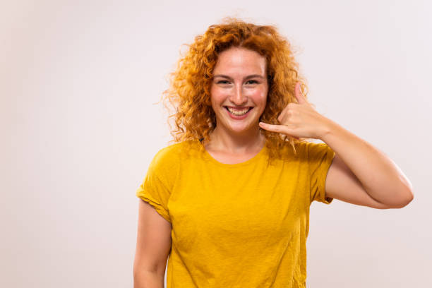 istock Ginger woman  showing call me gesture 1763098906