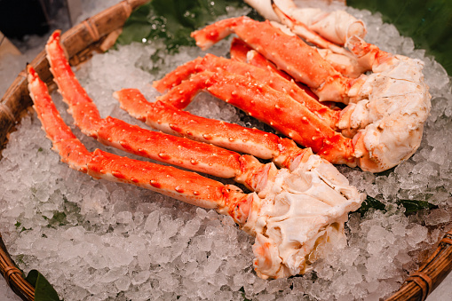 Cooked king crab legs being sold on crushed ice