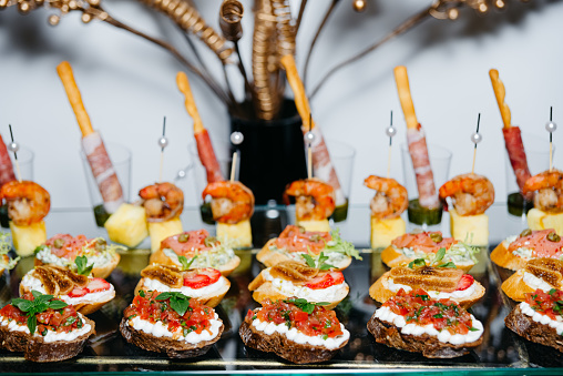 Rye bread bruschetta: cream cheese and salsa, cream cheese with figs with strawberries, cream cheese and salmon, shrimp and pineapple canapes on skewers