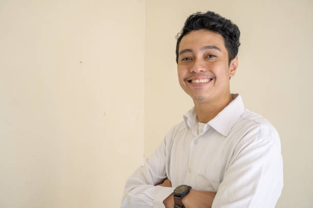 istock Young Indonesian curly man wear white clothes with cheer pose. 1763147421