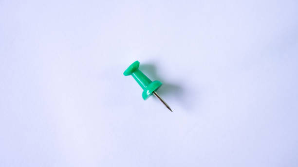 istock push pin, green, white background, macro photography 1763155785
