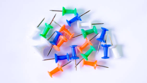 istock push pins, various colors, white background, macro photography 1763156864