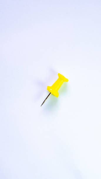 istock push pin, yellow, white background, macro photography 1763158464