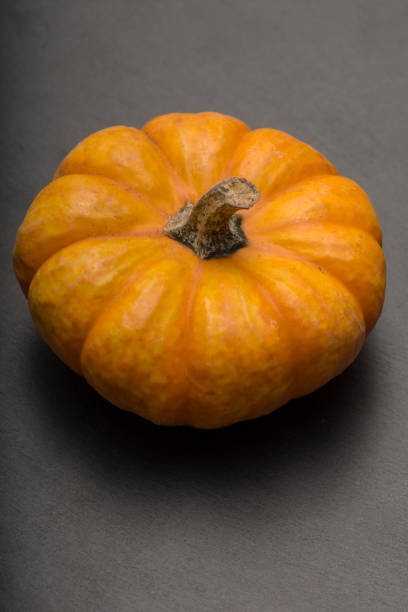 istock Closeup of one pumpkin on black background 1763162093
