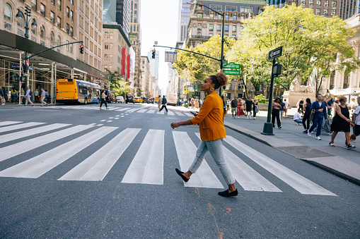 Woman in business, office worker, walking in New York midtown Manhattan.