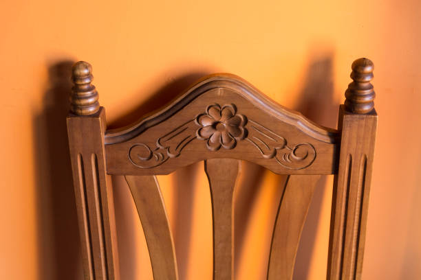 Wood dinner chair in house and sunlight on sunset.