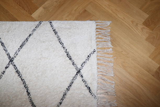 Scandinavian-style carpet on a wooden parquet stock photo