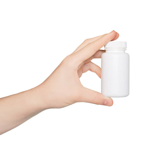 istock Hand with empty pill bottle isolated on white background. Bottle with pills. Mockup. 1763222645