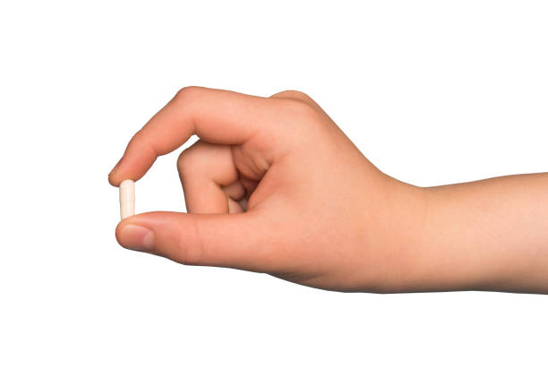 istock Hand holding the supplements capsule isolated on white background 1763223788