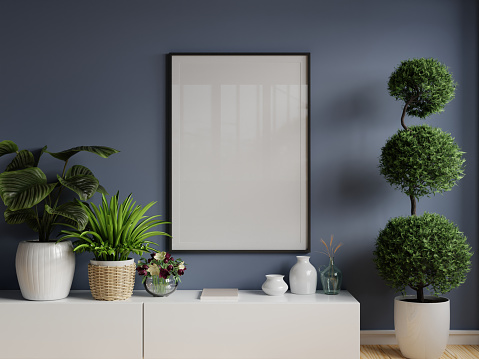 Poster mockup with wooden frame in home interior on blue wall background.3d rendering