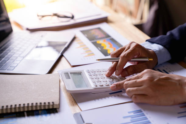 istock Close up woman hand using a calculator and writing make note, Tax Calculator And Pen, doing his accounting, financial adviser working, managing budget, finance and investment, accounting 1763237026