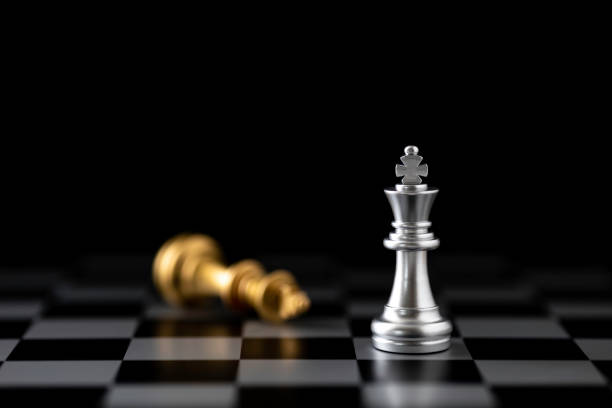 istock Silver king chess standing and Golden king chess falling on chess board. 1763272655