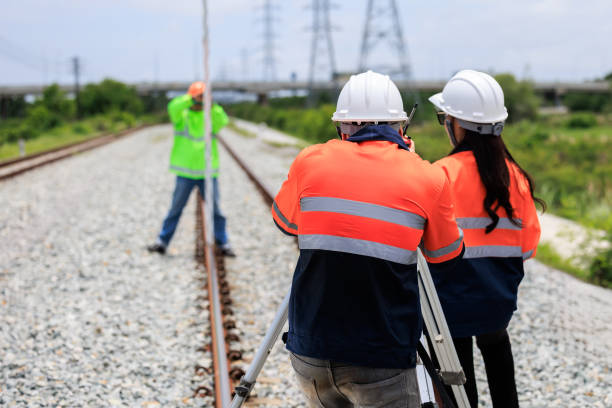 istock Engineer use theodolite equipment and Blueprint surveying construction worker on Railway site. 1763278439