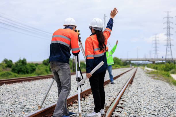 istock Engineer use theodolite equipment and Blueprint surveying construction worker on Railway site. 1763280216