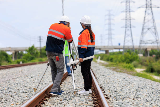 istock Engineer use theodolite equipment and Blueprint surveying construction worker on Railway site. 1763280746