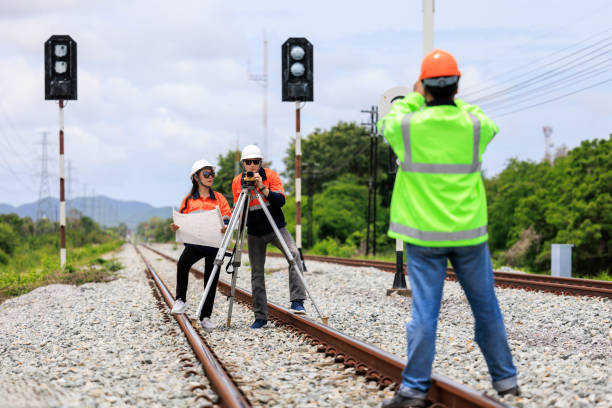 istock Engineer use theodolite equipment and Blueprint surveying construction worker on Railway site. 1763282383