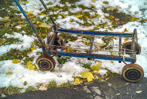 DIY empty four wheels trolley abandoned outdoor, winter scenery