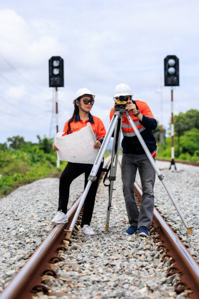 istock Engineer use theodolite equipment and Blueprint surveying construction worker on Railway site. 1763298647
